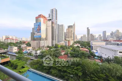 Stunning cityscape view from balcony overlooking lush greenery and modern skyline.