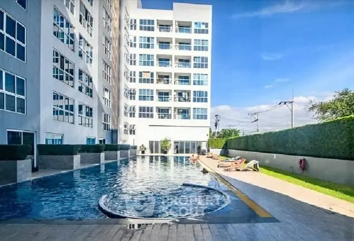 Luxurious condominium with a stunning outdoor pool and modern architecture, perfect for relaxation and leisure.