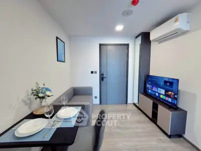 Modern living room with sleek furniture and smart TV, perfect for urban living.