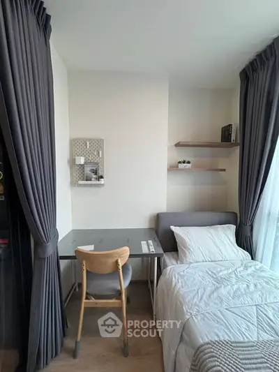 Cozy bedroom with study area and modern decor, perfect for urban living.