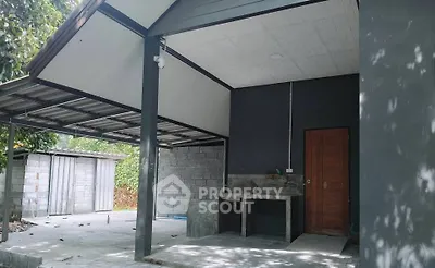 Modern outdoor space with covered area and concrete sink, ideal for versatile use.