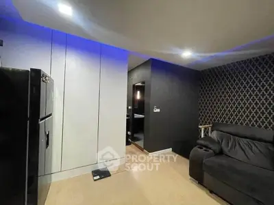 Modern living room with sleek black sofa and stylish lighting