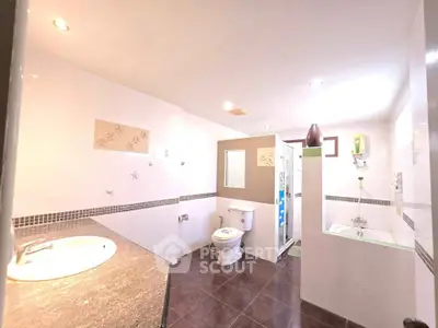 Spacious modern bathroom with sleek fixtures and ample lighting
