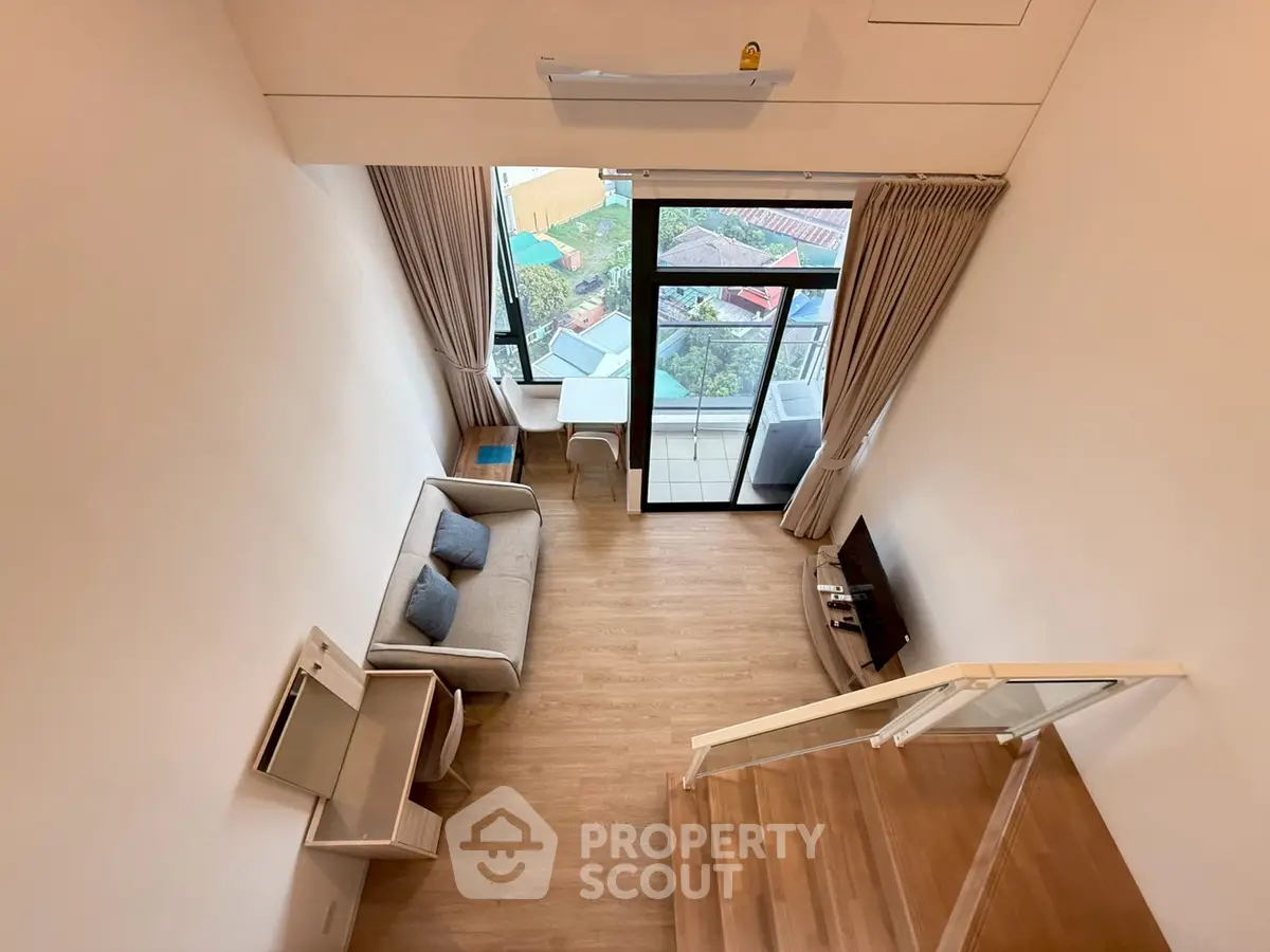 Modern loft living room with high ceiling and balcony view