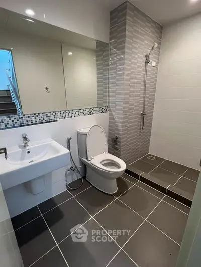 Modern bathroom with sleek design, featuring a walk-in shower and stylish tile work.