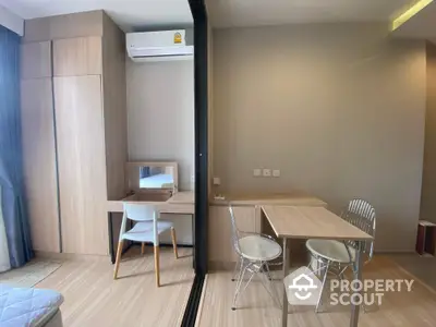 Modern studio apartment with wooden flooring and compact dining area