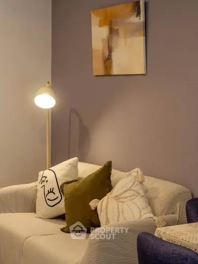 Cozy living room with stylish sofa, decorative pillows, and modern floor lamp
