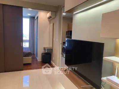 Modern apartment interior with sleek living room and cozy bedroom, featuring stylish furniture and natural light.