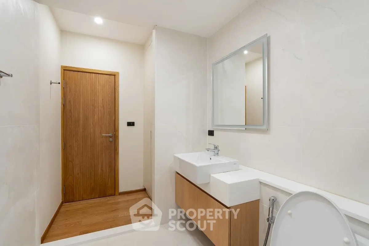 Modern bathroom with dual sinks and wooden accents