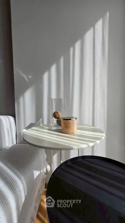 Cozy interior with a side table and soft lighting, perfect for relaxation.