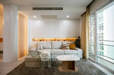 Modern living room with cozy sectional sofa and balcony view