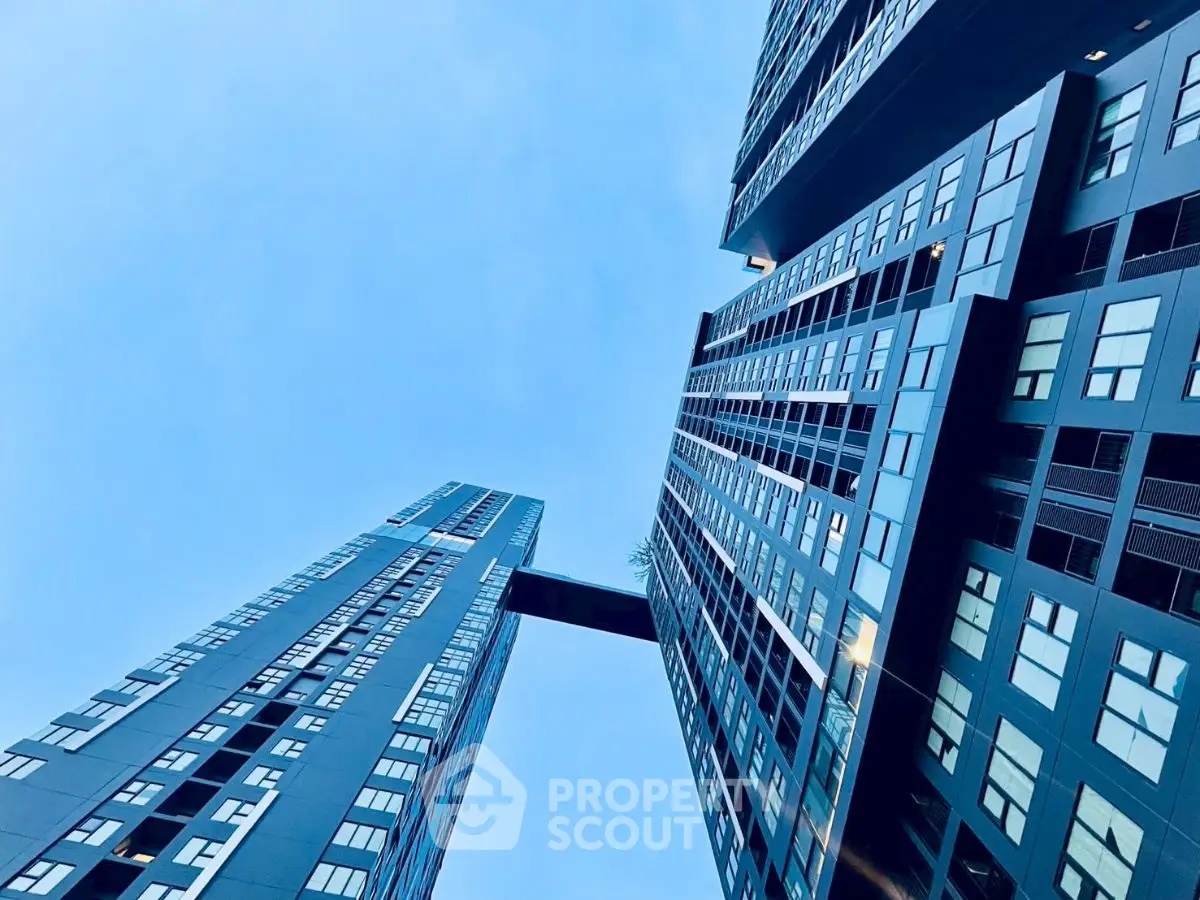 Stunning modern skyscrapers with sleek architecture against a clear blue sky.