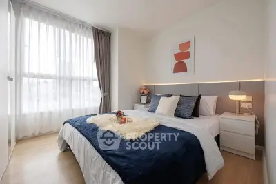 Modern bedroom with stylish decor and large window for natural light