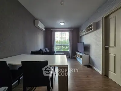 Modern living room with sleek furniture and large window view