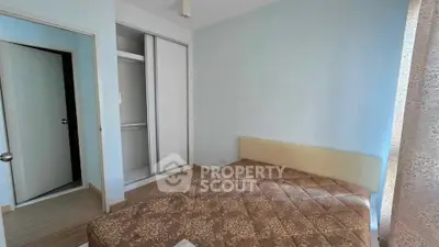 Cozy bedroom with built-in closet and natural light, perfect for restful nights.