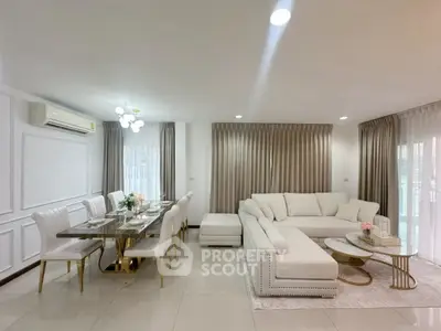 Luxurious open-plan living and dining area with elegant decor and ample natural light.