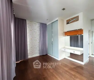 Spacious room with elegant wooden flooring and modern decor
