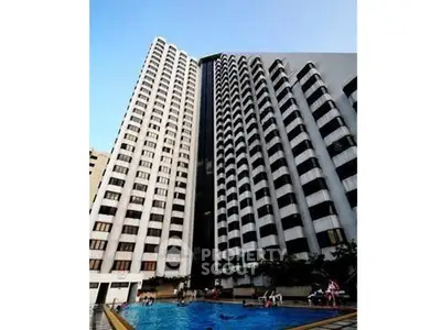 Stunning high-rise building with a luxurious swimming pool, perfect for urban living.