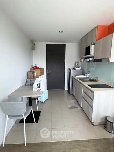 Modern compact kitchen with dining area in a stylish apartment