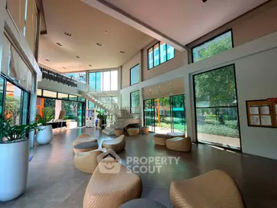 Spacious modern lobby with stylish seating and large windows offering garden views.