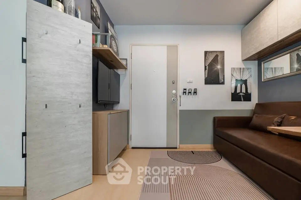 Modern living room with stylish decor and sleek furniture, featuring a cozy sofa and contemporary wall art.