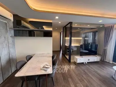 Modern living room with elegant dining area and stylish lighting in a contemporary apartment.