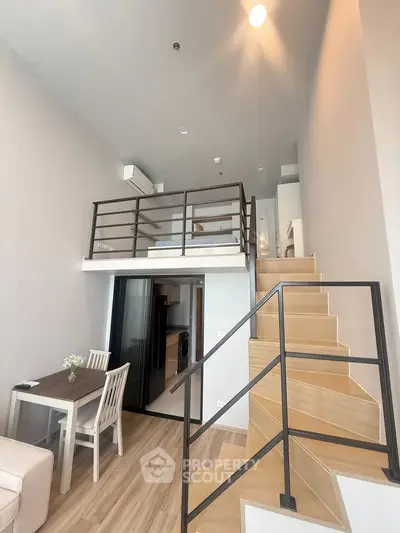 Modern loft apartment with mezzanine bedroom and stylish wooden staircase