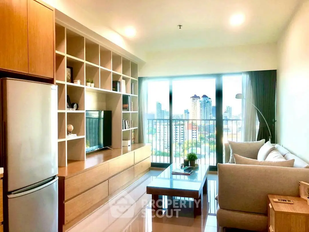 Modern living room with city view, featuring sleek furniture and large windows.