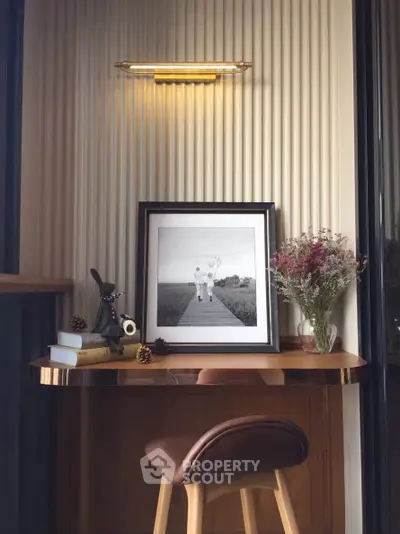 Chic study nook with elegant lighting and framed art, perfect for a cozy home office setup.