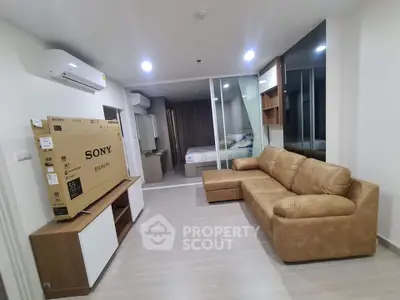 Modern living room with stylish furniture and a new TV in a contemporary apartment.
