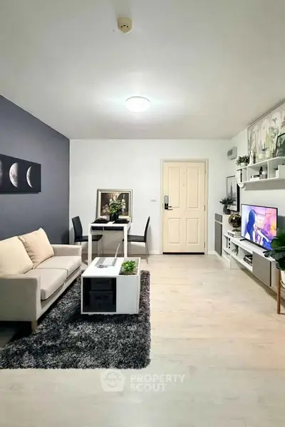 Modern living room with stylish decor, cozy sofa, and dining area, perfect for relaxation and entertainment.
