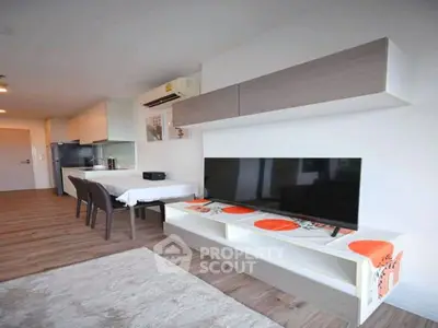 Modern living room with sleek furniture and open kitchen layout