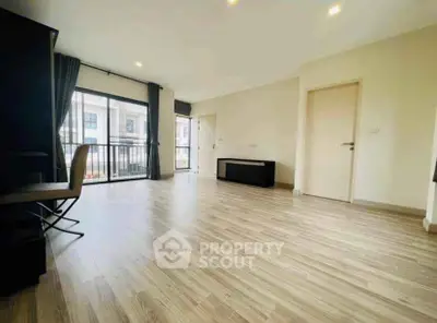 Spacious modern living room with wooden flooring and large windows