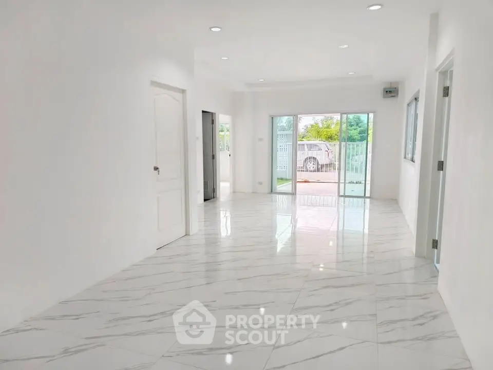 Spacious modern living room with marble flooring and large windows