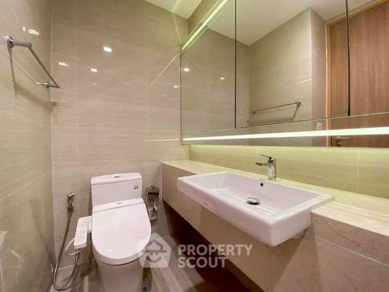 Modern bathroom with sleek fixtures and large mirror