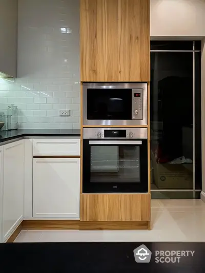 Modern kitchen with built-in oven and sleek cabinetry