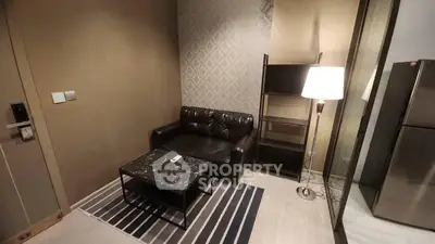 Cozy living room with leather sofa and modern decor in a stylish apartment.