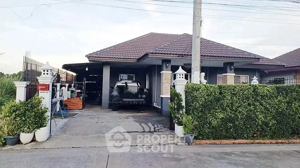 Charming single-story home with spacious driveway and lush greenery, perfect for family living.
