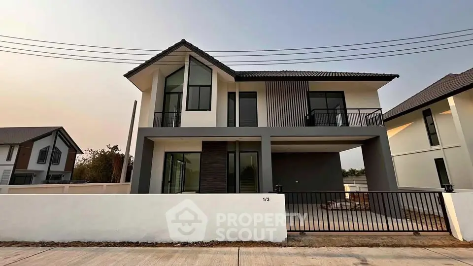 Modern two-story house with sleek design and spacious balcony in a serene neighborhood.