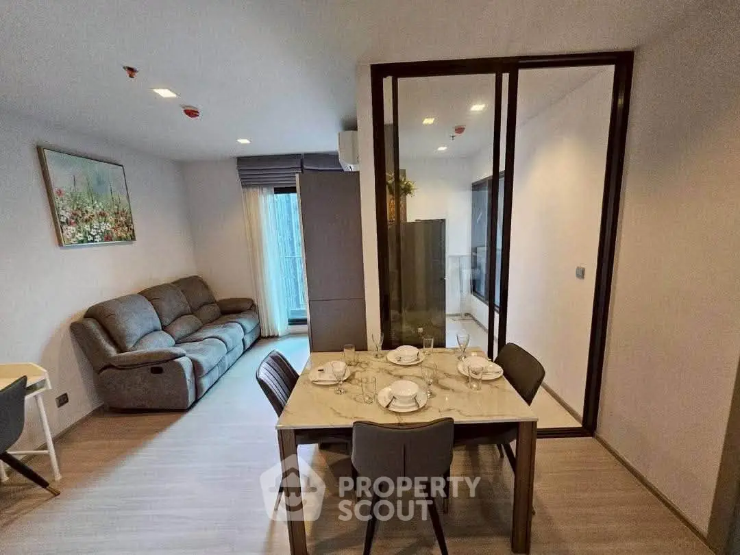 Modern living room with dining area and stylish decor in a cozy apartment.