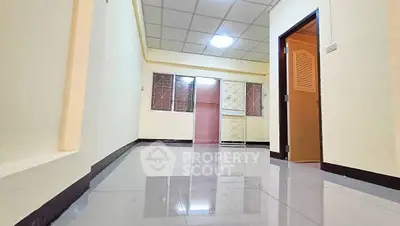 Spacious hallway with glossy tiled floor and modern ceiling lights