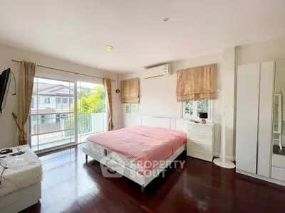 Spacious bedroom with balcony access and modern furnishings