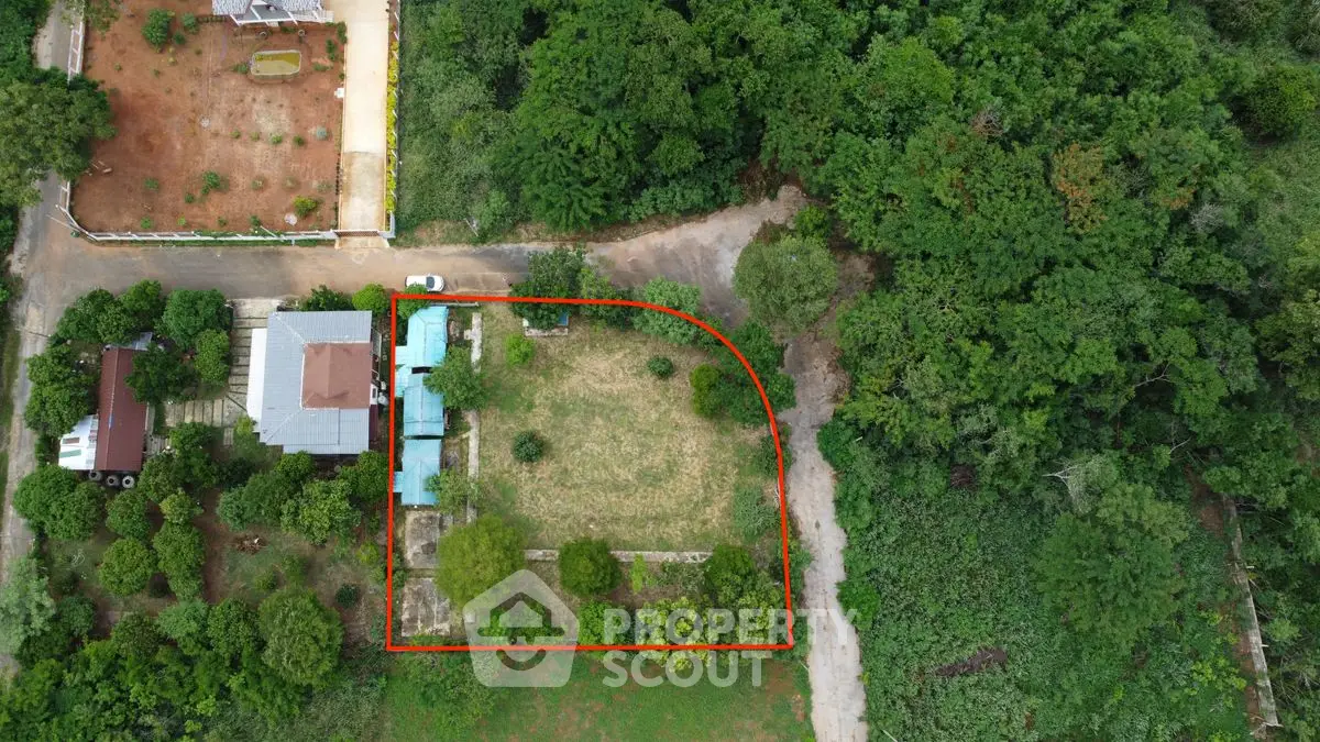 Aerial view of a property with lush greenery and a spacious garden area.