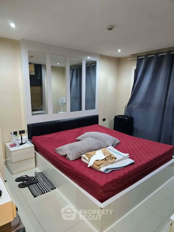 Cozy bedroom with modern design and large bed, perfect for relaxation.