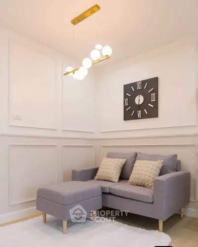 Cozy living room with modern sofa and stylish wall clock