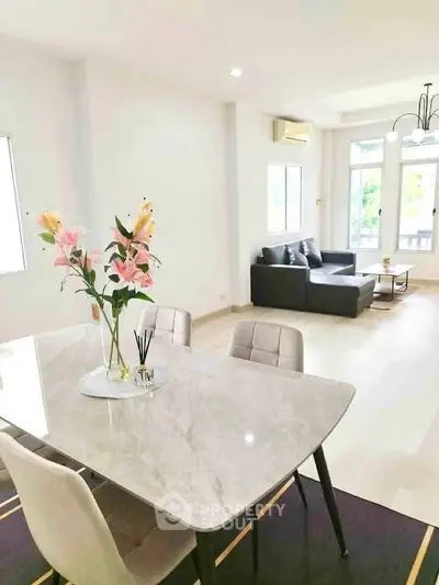 Spacious modern living room with elegant dining area and natural light