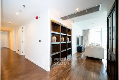 Spacious modern living room with wooden flooring and elegant decor in a luxury apartment.