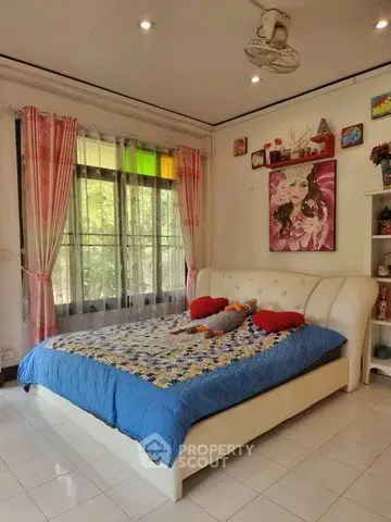 Charming bedroom with colorful decor and large window view