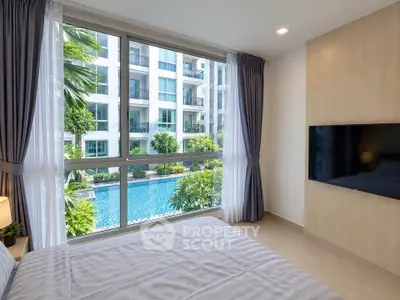 Luxurious bedroom with pool view in modern apartment complex
