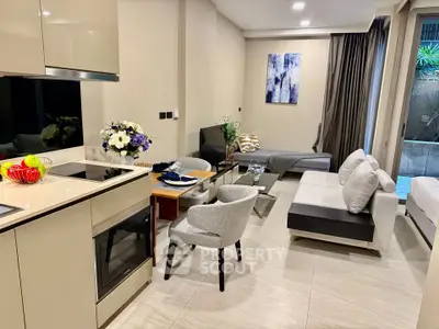 Modern living room with sleek kitchen and stylish decor in open layout apartment